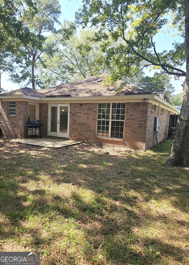 back of house featuring a yard and a patio