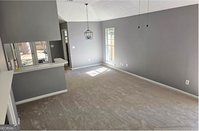 unfurnished living room with dark carpet and vaulted ceiling