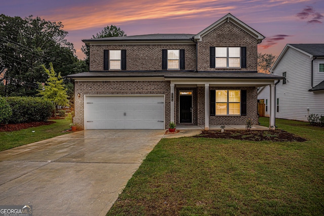 front facade with a yard, a porch, and a garage