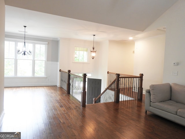 living room with an inviting chandelier, dark hardwood / wood-style floors, and crown molding