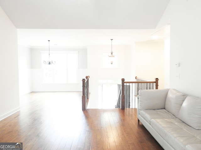 living room with a notable chandelier and hardwood / wood-style flooring