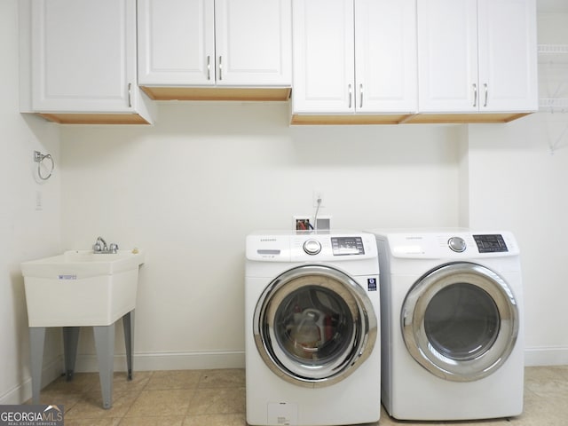 laundry room with separate washer and dryer, cabinets, sink, and light tile patterned floors