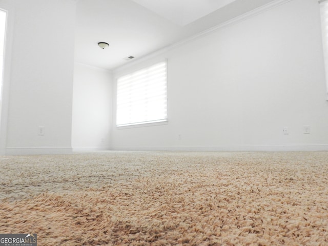 unfurnished room with crown molding