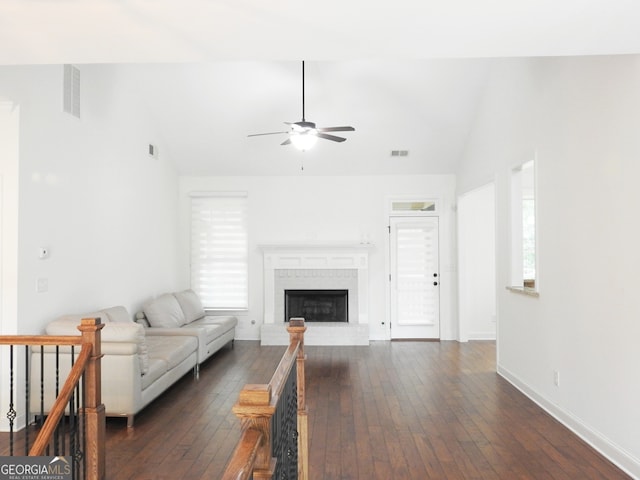 unfurnished living room featuring a wealth of natural light, vaulted ceiling, ceiling fan, and dark hardwood / wood-style floors