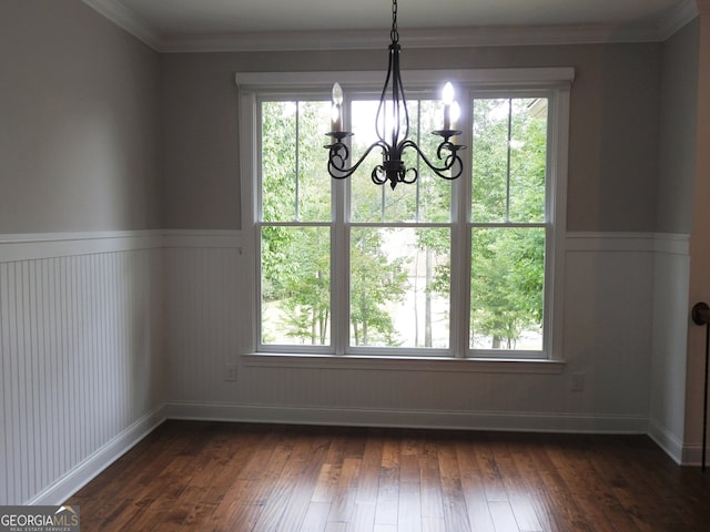 unfurnished dining area with ornamental molding, an inviting chandelier, dark hardwood / wood-style flooring, and a healthy amount of sunlight