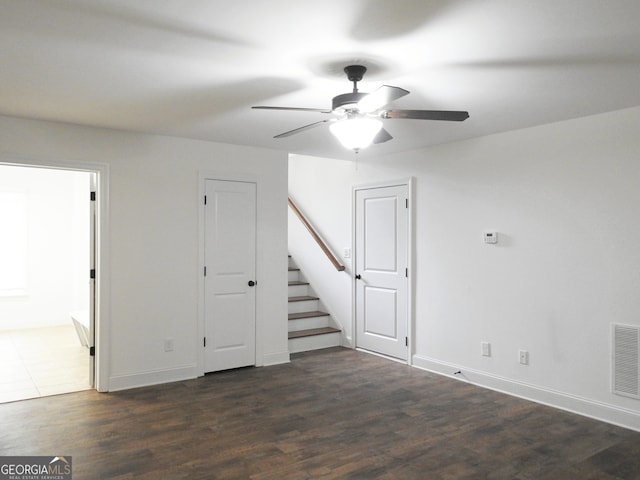 interior space with ceiling fan and dark wood-type flooring