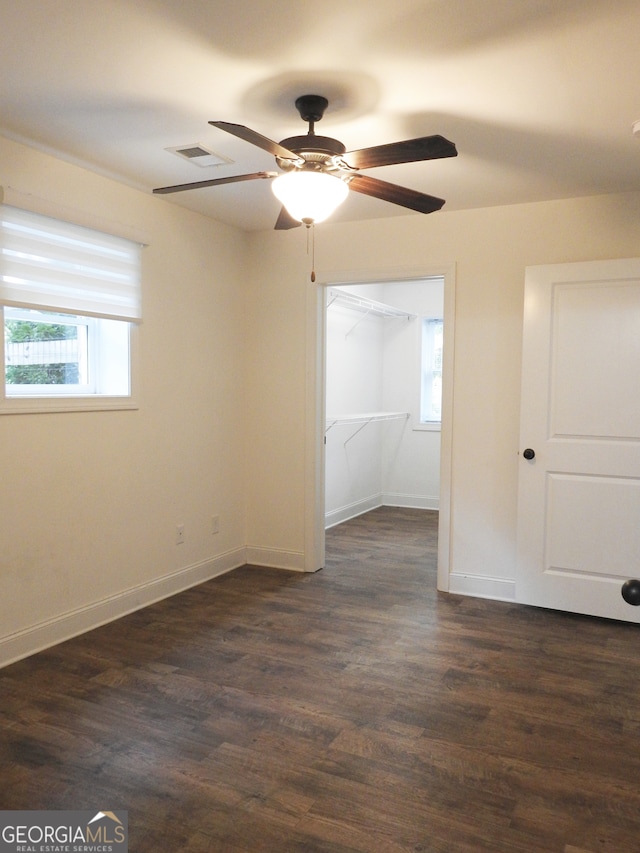 unfurnished room featuring ceiling fan and dark hardwood / wood-style flooring