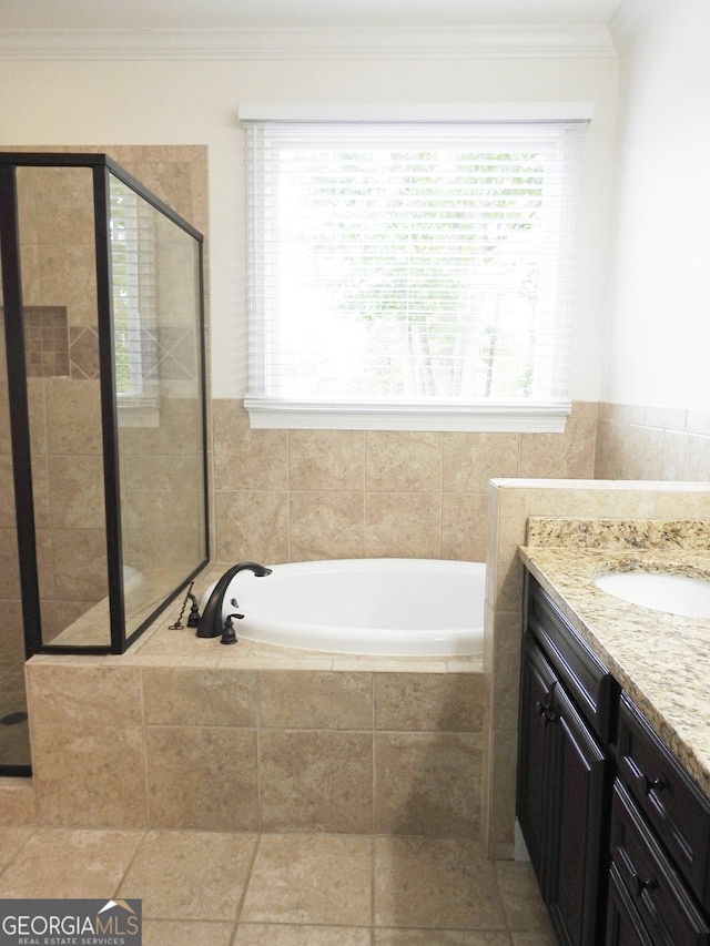 bathroom with plus walk in shower, ornamental molding, and vanity