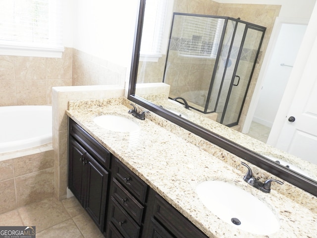 bathroom featuring independent shower and bath, vanity, and tile patterned flooring