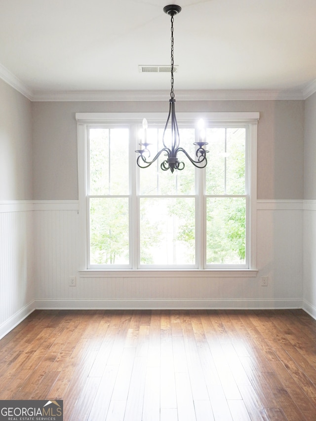 unfurnished dining area featuring hardwood / wood-style floors and a wealth of natural light