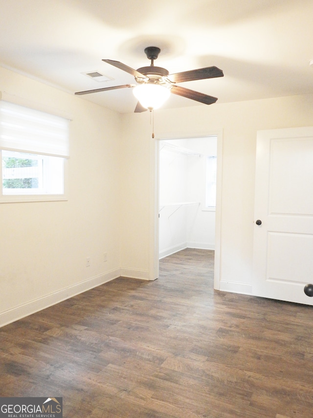 unfurnished room featuring ceiling fan and dark hardwood / wood-style flooring