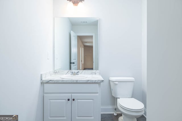 bathroom with vanity and toilet