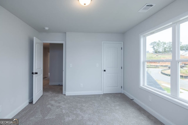 unfurnished bedroom with light carpet