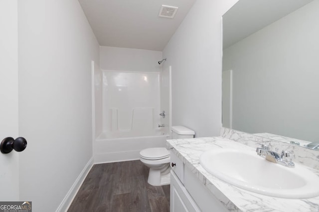 full bathroom featuring tub / shower combination, vanity, toilet, and hardwood / wood-style flooring