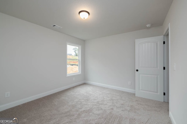 unfurnished room with light carpet