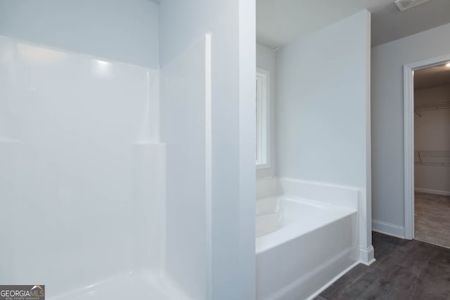 bathroom featuring a bathing tub and hardwood / wood-style flooring