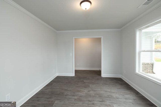 spare room with crown molding and dark hardwood / wood-style floors