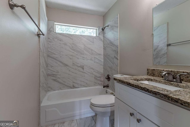 full bathroom featuring vanity, tiled shower / bath combo, toilet, and a textured ceiling