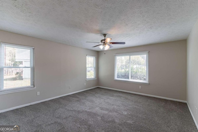 carpeted empty room with a textured ceiling and ceiling fan