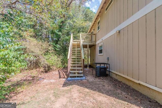 view of yard featuring a deck and central air condition unit