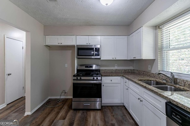 kitchen with stainless steel appliances, sink, dark hardwood / wood-style flooring, and white cabinetry