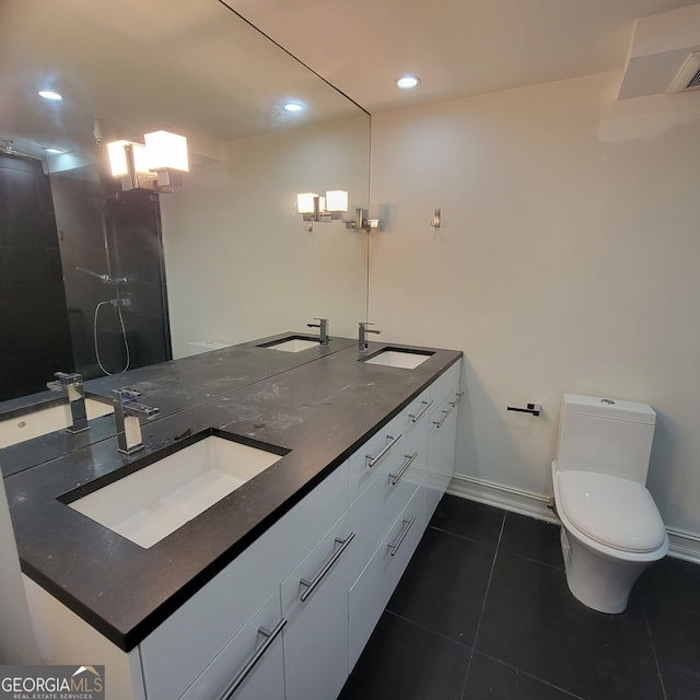 bathroom featuring vanity, toilet, and tile patterned flooring