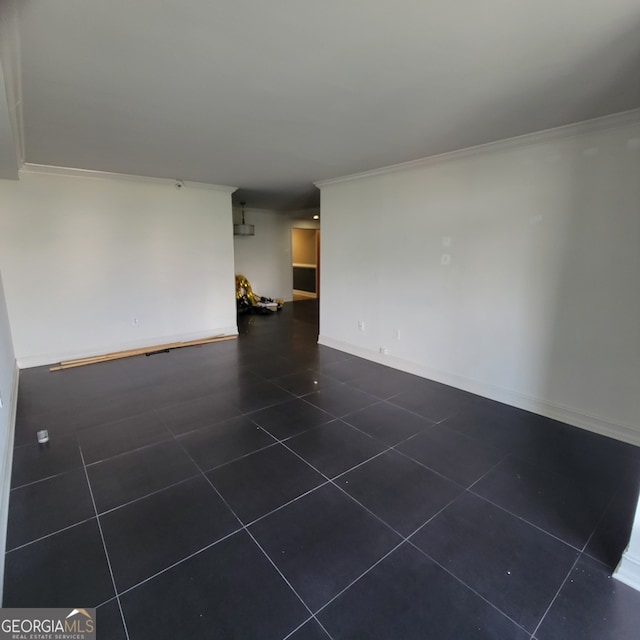 tiled spare room with crown molding