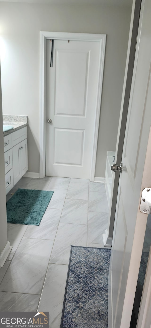 bathroom with vanity and a bathing tub