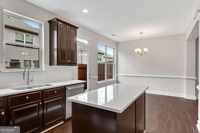 kitchen featuring dishwasher, a center island, dark hardwood / wood-style floors, and decorative light fixtures