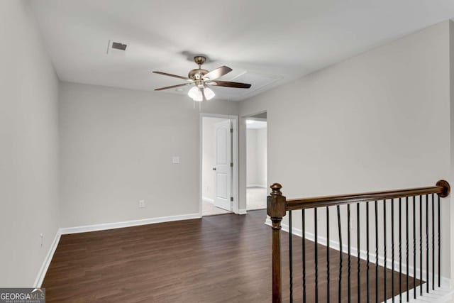 unfurnished room featuring ceiling fan and dark wood-type flooring