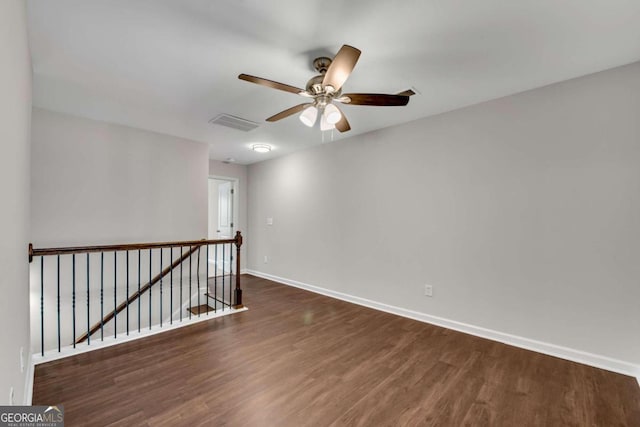 unfurnished room featuring ceiling fan and dark hardwood / wood-style floors