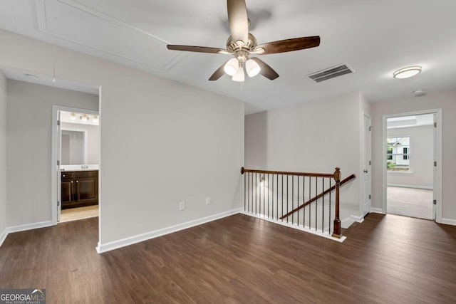 spare room with ceiling fan and dark hardwood / wood-style flooring