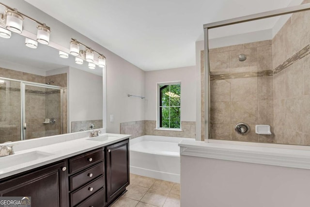 bathroom with tile patterned floors, independent shower and bath, and vanity