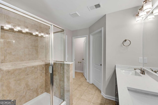 bathroom featuring vanity, tile patterned flooring, and an enclosed shower