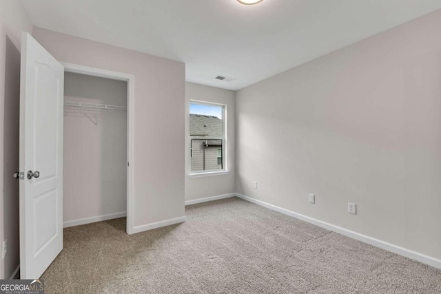 unfurnished bedroom with a closet and carpet