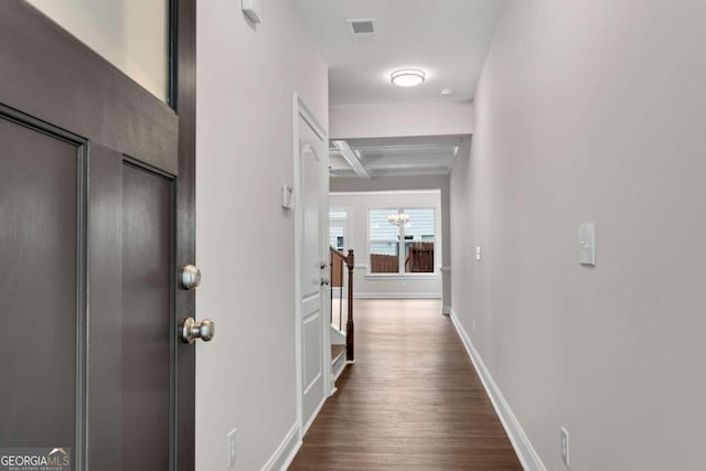 hall featuring beamed ceiling and dark hardwood / wood-style floors