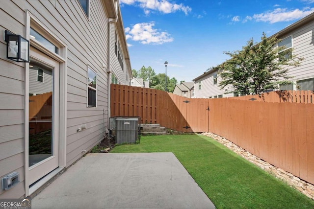 view of yard with a patio and central AC