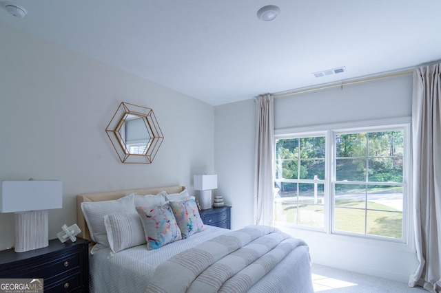 bedroom with light colored carpet