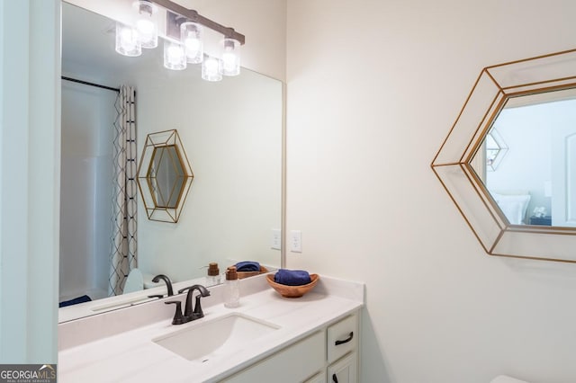 bathroom featuring vanity and curtained shower