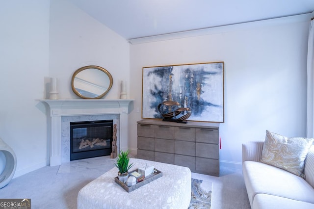 carpeted living room with a premium fireplace