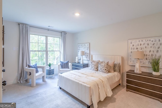 bedroom featuring light carpet