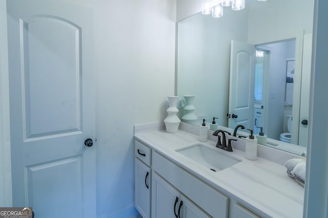 bathroom featuring vanity and toilet