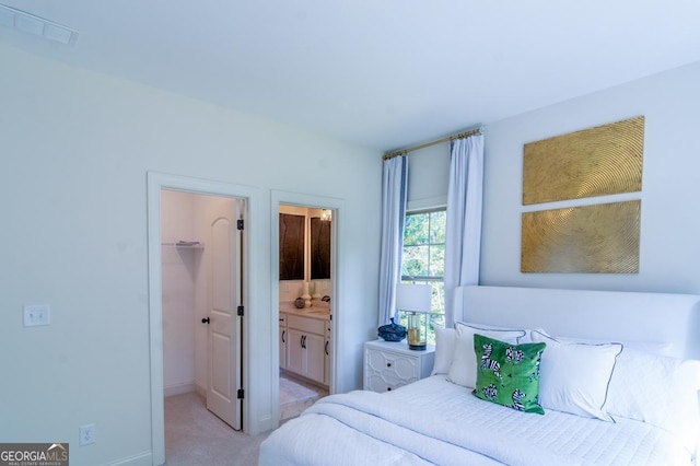 carpeted bedroom featuring ensuite bathroom, a walk in closet, and a closet