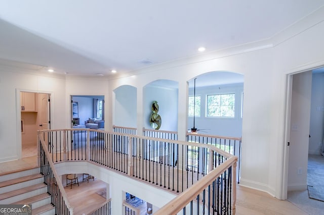 hall with light hardwood / wood-style flooring and ornamental molding