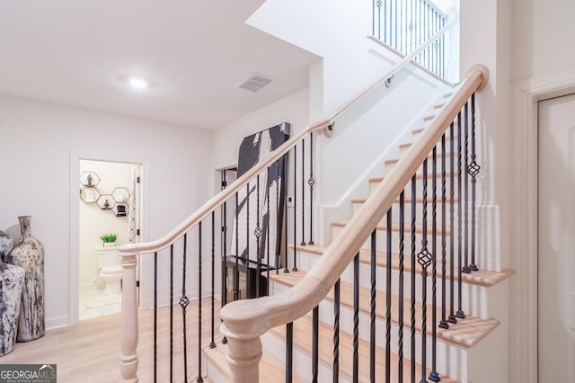 staircase with hardwood / wood-style floors