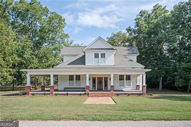 farmhouse inspired home with a front yard and covered porch