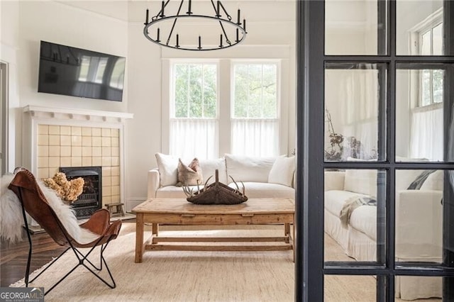 sunroom with a fireplace and a chandelier