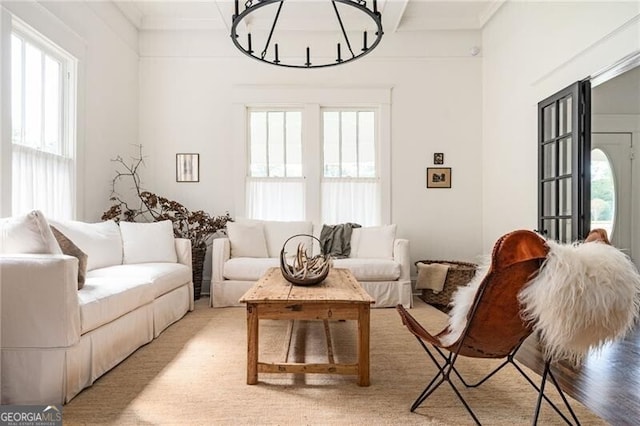 sitting room featuring ornamental molding and light wood-type flooring