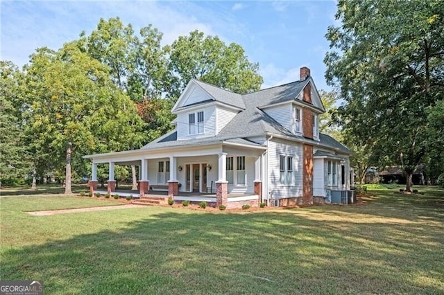 view of front of property featuring a porch, central AC unit, and a front lawn