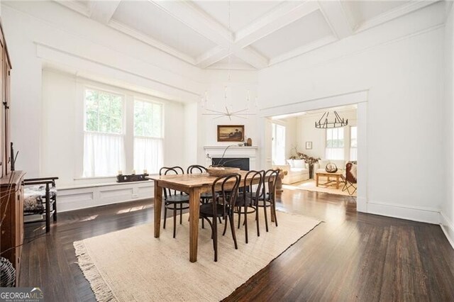 dining space featuring a healthy amount of sunlight, coffered ceiling, and dark hardwood / wood-style flooring